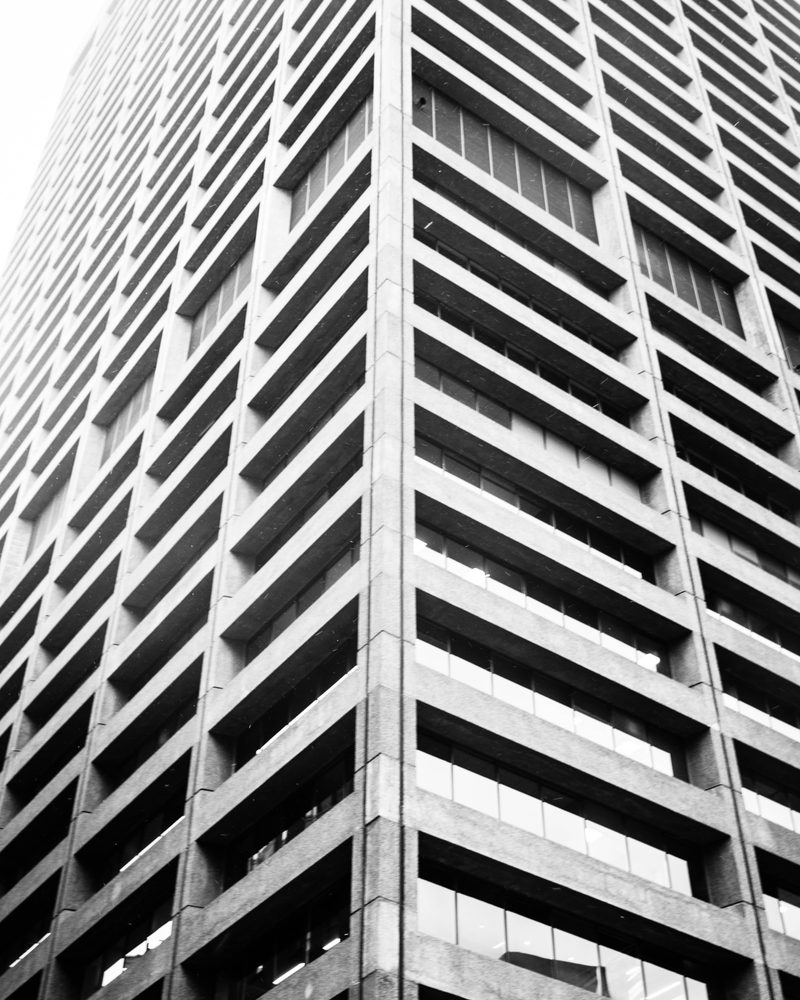 Black-and-white low-angle of a tower grid facade